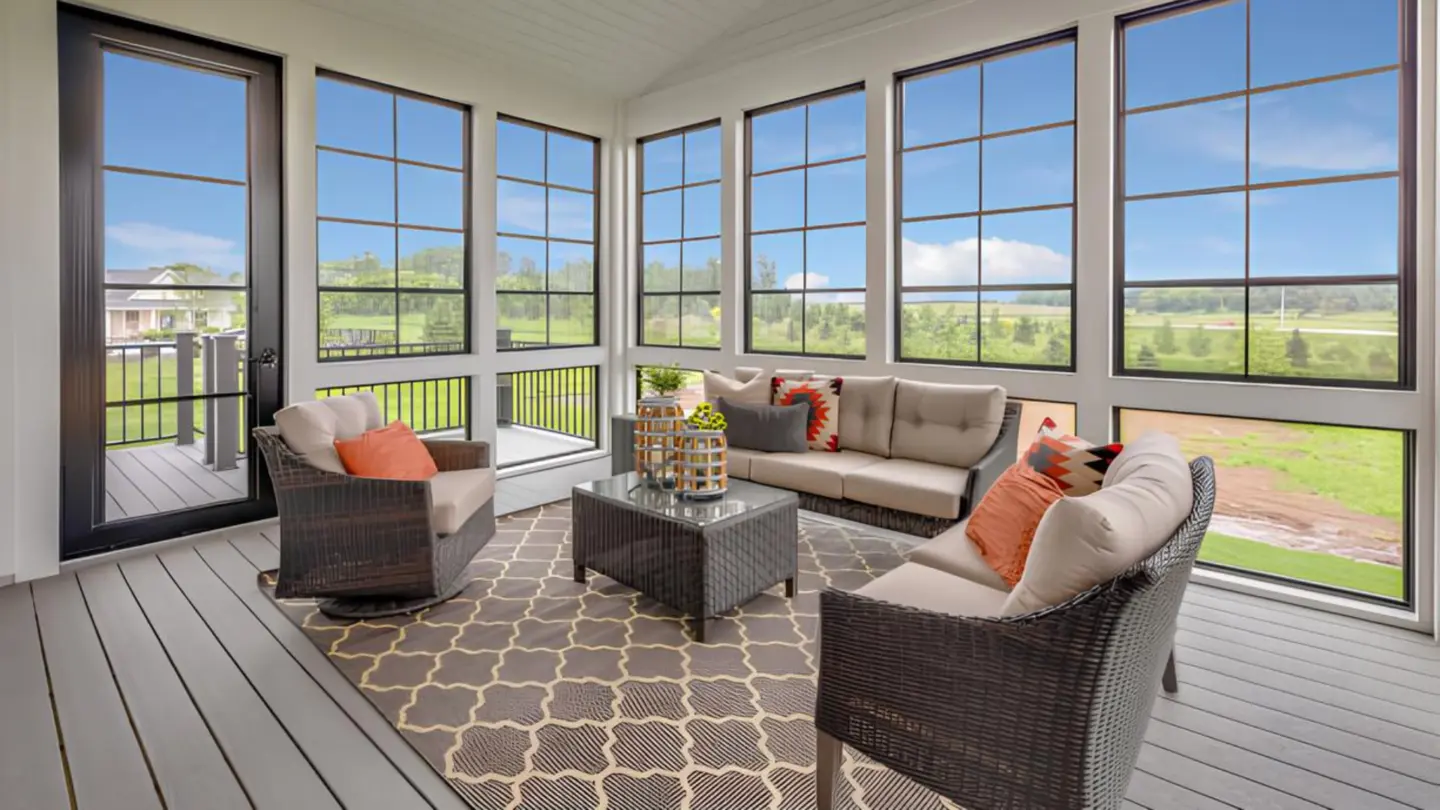 3-season-sunroom-installation-on-the-custom-deck-with-couch-and-small-table-with-overlooking-view-in-southern-maryland