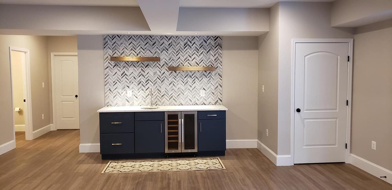 basement-finishing-with-spacious-area-and-dark-theme-drawer-with-three-white-doors-in-huntingtown-maryland