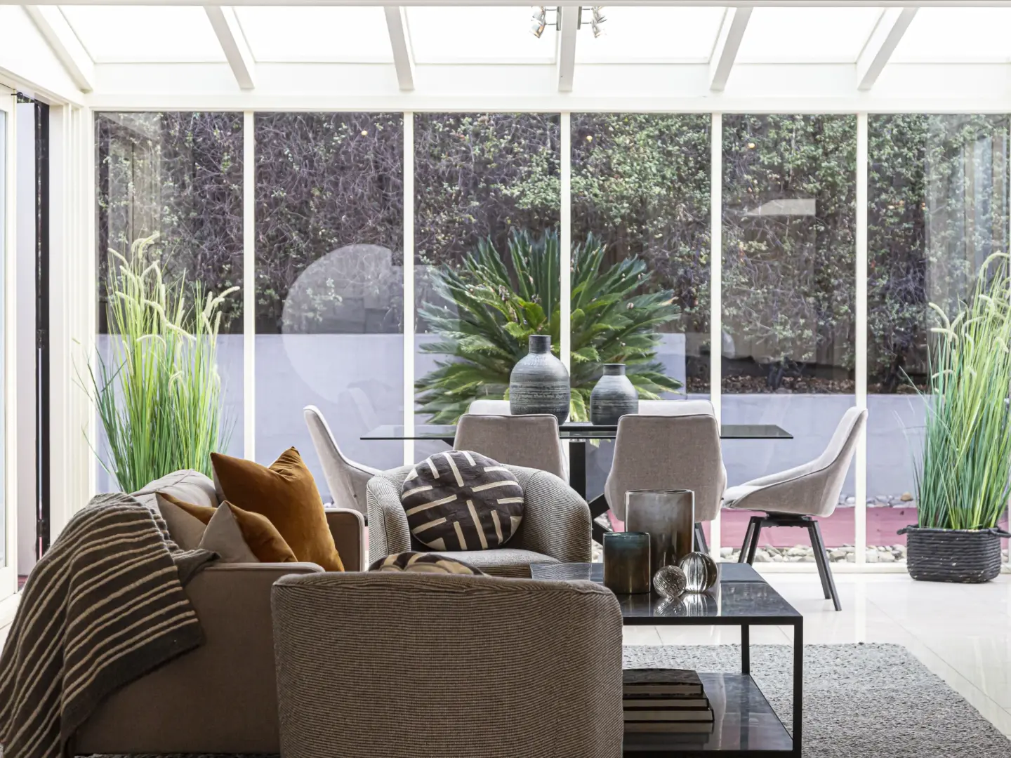 bright-sunny-living-room-sunroom-with-couches-and-table-with-dining-set-area-in-southern-maryland