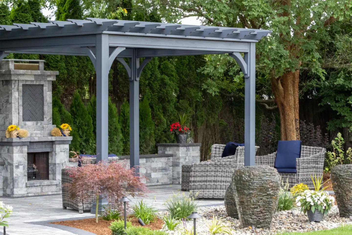 landscape-architecture-featuring-gray-pergola-and-stone-fire-place-with-outdoor-living-sofa-in-southern-maryland