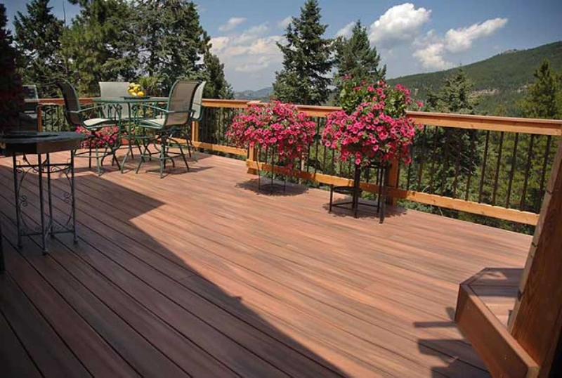 residential-hard-wood-custom-deck-with-beautiful-plants-decorations-and-outdoor-living-dining-set-area-with-overlooking-mountain-and-sky-view-on-the-background-in-southern-maryland