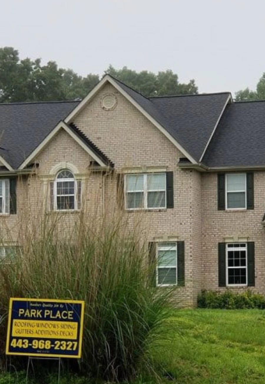 residential-roofing-project-brick-home-with-park-place-construction-logo-and-contact-info-in-southern-maryland