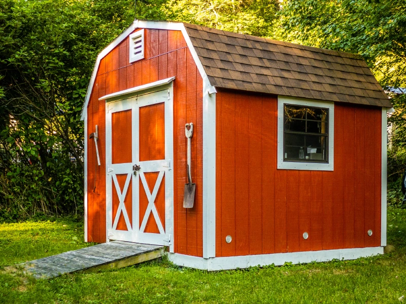 shed-builder-with-hanging-shovel-and-pickaxe-surrounded-by-trees-and-grass-in-southern-maryland